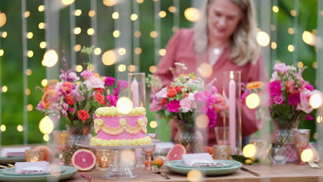 Fairy-Light-Foreground-With-Beautiful-Styled-Wedding-Party-Table-Setting-In-Outdoor-Garden-With-Pink-Cake-And-Florals,-4K-Slow-Motion