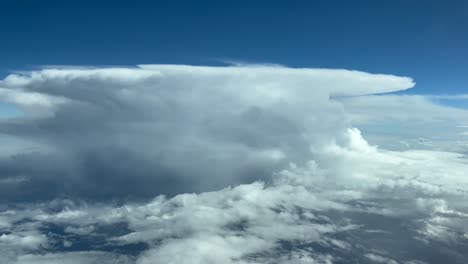 Pilot-POV-FPV-flying-in-a-turbulent-sky-with-a-massive-and-dangerous-cumulonimbus-storm-cloud