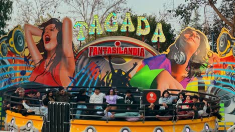 Group-of-people-enjoying-a-continuously-rotating-game,-Fantasilandia-amusement-park,-Santiago,-Chile