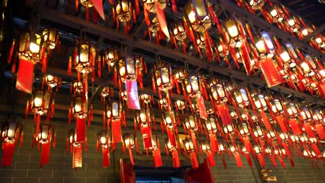 Ceiling-lamps-with-red-wishing-cards-hanging-at-Tin-Hau-Temple-in-Hong-Kong,-China