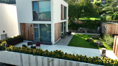 a-cinematic-drone-shot-of-a-small-corner-villa-with-a-garden-surrounded-by-sunflowers---DJI-mavic-3