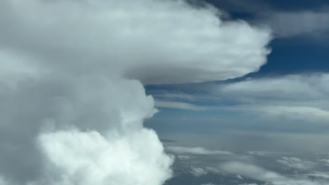 Immersive-pilot-POV-FPV-flying-near-the-top-of-a-huge-perfect-cumulonimbus-storm-cloud-with-an-anvil-shape