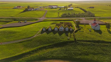 Experience-the-serene-beauty-of-Skagafjörður,-where-drone-footage-unveils-the-stunning-fjords-and-lush-valleys-surrounding-this-historic-Viking-village