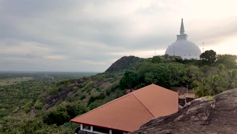 Golden-hour-view-of-the-White-Stupa-at-Mihintale-Hill-in-Sri-Lanka,-showcasing-serene-landscapes-and-architectural-beauty