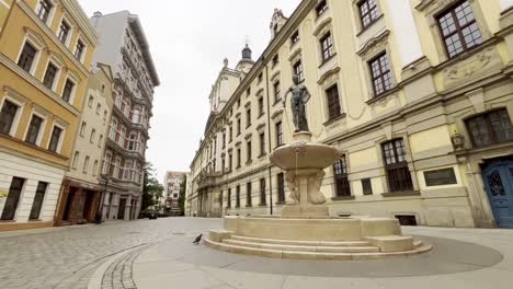 4K-cinematic-of-Wroclaw-University-building-and-The-Swordsman-Fountain-early-morning-with-no-people