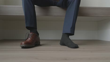 Static-shot-of-a-man-putting-his-shoes-on