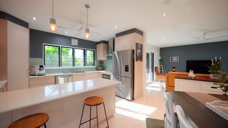 Modern-open-plan-kitchen-and-loungeroom-with-sleek-furnishings-and-natural-lighting-in-a-contemporary-townhouse