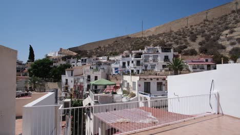 Eine-Nahaufnahme-Der-Wohnsiedlungen-Unterhalb-Der-Imposanten-Burg-Santa-Barbara-In-Alicante,-Spanien,-Mit-Lebendigen-Häusern-Vor-Der-Kulisse-Der-Historischen-Burg