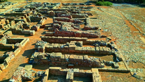 Aerial-view-around-the-ruins-of-the-Palace-of-Knossos-in-sunny-Crete,-Greece