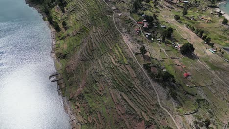 Flyover-dramatic-green-terraced-hillsides-on-Taquile-Island-in-Peru