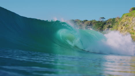 Slow-motion-view-of-an-early-morning-wave-gently-rolling-in,-filmed-from-the-shore,-highlighting-the-calmness-and-fluidity-of-the-ocean