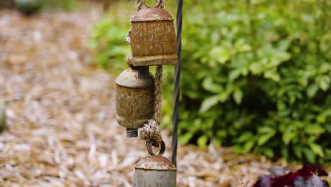 Camera-slow-motion-footage-with-color-look-at-decorative-bells-in-a-garden