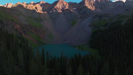 Lower-Blue-Lake-sunset-dusk-Mount-Sneffels-Wilderness-Ridgway-Telluride-Colorado-aerial-drone-golden-hour-shaded-peaks-San-Juan-Rocky-Mountains-Uncompahgre-National-Forest-blue-sky-left-pan-up-circle