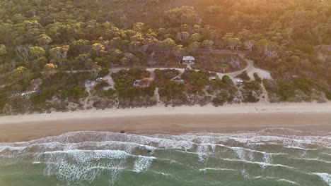 Aerial-slow-motion-shot-over-the-Coles-bay-campground-and-ocean-front