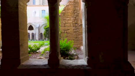 Slow-motion-dolly-shot-of-archways-revealing-the-beautiful-garden-courtyard