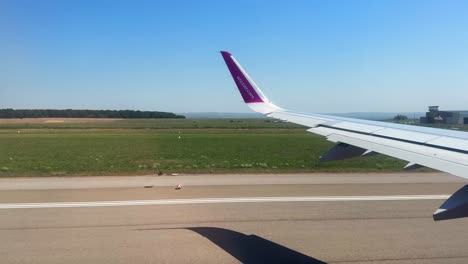 Plane-window-view-takeoff-Suceava-Airport-in-Romania,-fly-airplane-wing-view