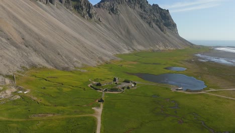 Witness-the-enchanting-beauty-of-Iceland’s-Viking-Village-as-the-drone-glides-over-quaint-buildings-and-lush-greenery,-revealing-a-rich-tapestry-of-history-and-scenery