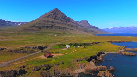 Explore-the-untouched-wilderness-of-Iceland-with-a-bird’s-eye-view-of-Djúpivogur,-where-majestic-mountains-rise-above-crystal-clear-waters