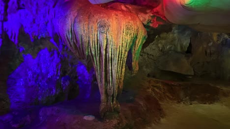 A-Beam-of-Vibrant-Light-Casting-Hues-Over-a-Limestone-Formation-Resembling-an-Elephant-at-Kek-Look-Tong-Cave-in-Ipoh,-Malaysia---Close-Up