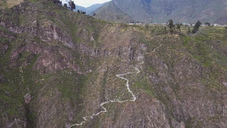 Aerial:-Switchback-footpath-trail-leads-into-steep-Colca-Canyon,-Peru