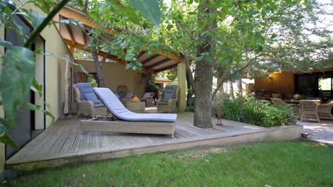 A-beautifully-arranged-garden-layout-with-a-balcony-featuring-leisure-chairs,-creating-a-relaxed-lounging-atmosphere-at-Maison-Vias,-France