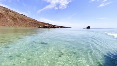 Peaceful-seashore-with-crystal-clear-water-on-a-sunny-day