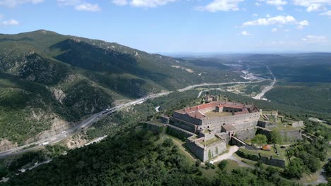 Panoramic-aerial-view-of-the-Fort-de-Bellegarde-from-afar,-Le-Perthus,-France