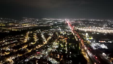 Static-nighttime-drone-shot-of-the-Mexico-Querétaro-Highway-looking-north-at-Cuautitlan-Izcalli,-featuring-vehicle-traffic-including-cars,-trucks,-and-public-transportation