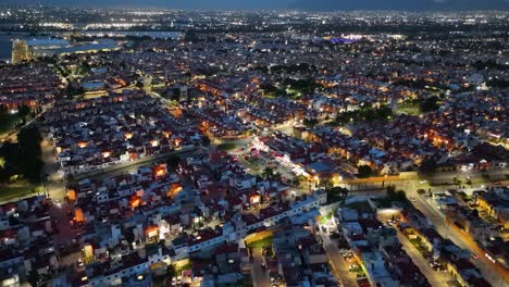 Nighttime-orbital-drone-shot-of-a-residential-subdivision-with-similar-houses-in-the-municipality-of-Cuautitlán-Izcalli,-part-of-the-Mexico-City-metropolitan-area