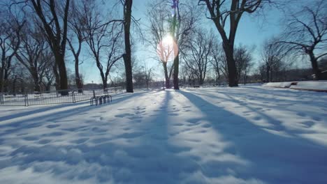 Drone-Fpv-shot-across-various-obstacles-rides-in-a-playground-during-winter