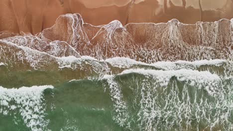 Slow-Motion-Drone-Footage-of-Waves-on-Golden-Sand-in-Lanta