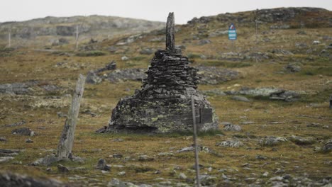 A-dark-weather-worn-stone-cairn-in-the-bleak-autumn-tundra