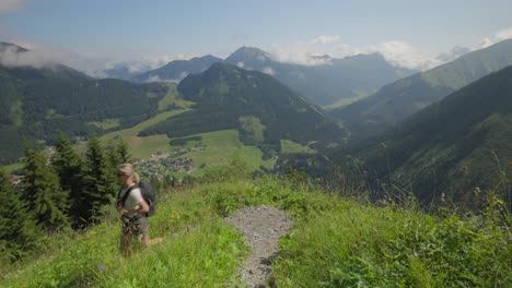 Woman-hiking-on-a-sunny-day-with-a-stunning-view-of-the-Austrian-mountains-in-Berwang