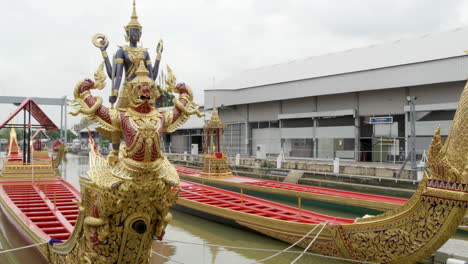 Panning-from-the-left-to-the-right-of-the-Thai-Royal-Barge-decorated-with-an-animal-figurehead-of-Narai-Song-Suban-is-docked-at-the-National-Museum-in-Bangkok,-Thailand