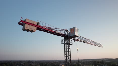 Big-tower-crane-with-counterweights-at-construction-site-in-city