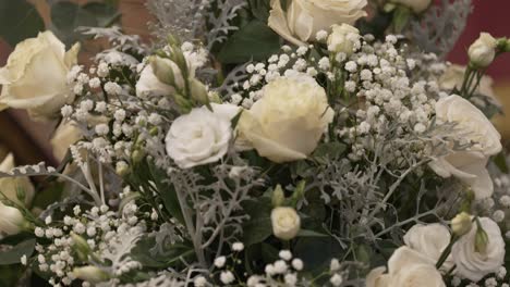 delicate-white-floral-arrangement-featuring-roses-and-baby's-breath,-creating-a-serene-and-elegant-display