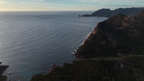 Coles-Bay-Conservation-Area-with-Freycinet-Mountain-in-Tasmania,-Australia-during-golden-sunrise