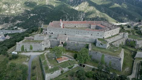 Aerial-flying-backwards-from-Bellegarde-Fort,-Le-Perthus,-France