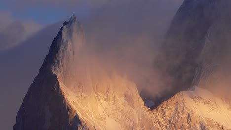 Dramatic-shot-of-Mount-Fitz-Roy-at-sunrise,-with-clouds-enveloping-the-peak,-soft-light