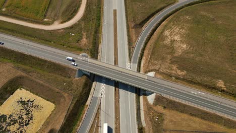 Overhead-aerial-view-of-expressway-highway-road-through-rural-fields-in-summer