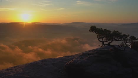 Timelapse-of-a-foggy-sunrise-at-the-Lilienstein-in-the-Elbe-Sandstone-Mountains,-Saxon-Switzerland,-Germany