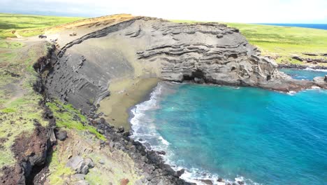Aerial-footage,-flying-in-to-reveal-the-Green-Sand-Beach-of-Hawaii's-Big-Island