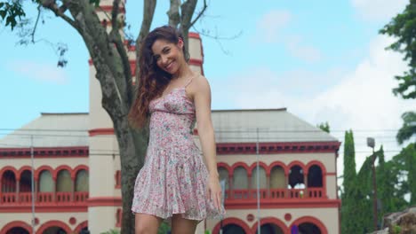 Young-girl-in-a-mini-dress-enjoys-herself-at-the-park-with-a-castle-in-the-background