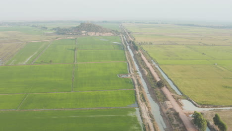 Beautiful-Bird’s-eye-view-of-irrigated-farmland-in-Cambodia-with-little-mountain