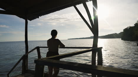Slow-motion-silhouette-shot-of-a-tourist-enjoying-the-views-of-the-ocean-in-Bohol