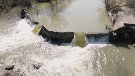 Slow-motion-shot-of-a-small-concrete-dam-at-the-West-Fork-White-River-Pump-Station
