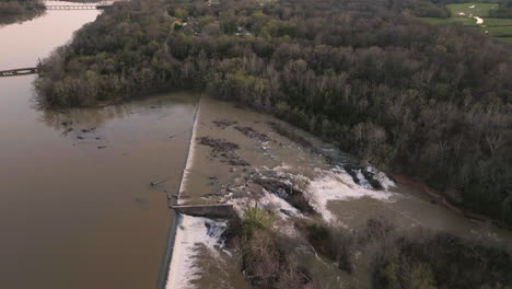 Aerial-shot-of-fallen-trees-in-a-fast-flowing-waterfall-section-within-Lake-Sequoyah