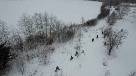 Bikers-Riding-Fatbike-On-Snowy-Trail-During-Winter-In-Minnesota,-USA