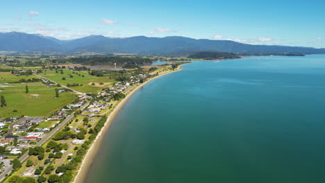 Amazing-aerial-view-of-Tarakohe-beach-shoreline-in-New-Zealand,-sunny-day
