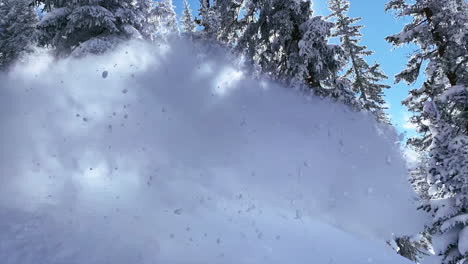 Male-Snowboarder-riding-down-fresh-powder-snow-high-speed-turn-blue-sky-steep-turns-Vail-Pass-Colorado